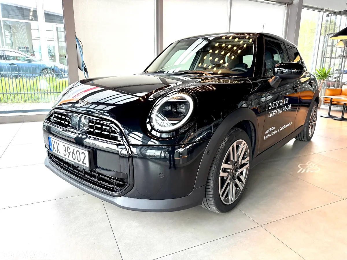 Jasne MINI Countryman w salonie, ujęcie przód-bok, przestronna strefa lounge w tle. Samochody MINI Kraków, Małopolska