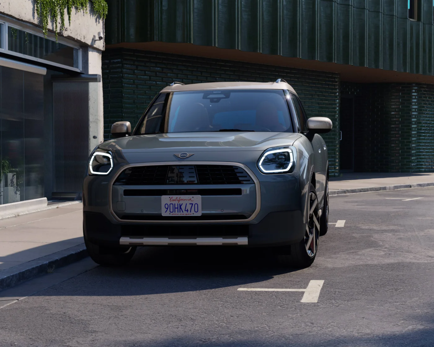 Nowe MINI Countryman ONE w wersji SUV prezentowane od przodu na miejskiej ulicy. Przestronne nadwozie i nowoczesny design modelu.